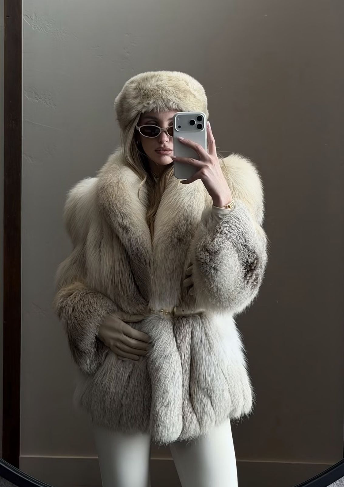 Mirror selfie in a cream fur coat and fur hat